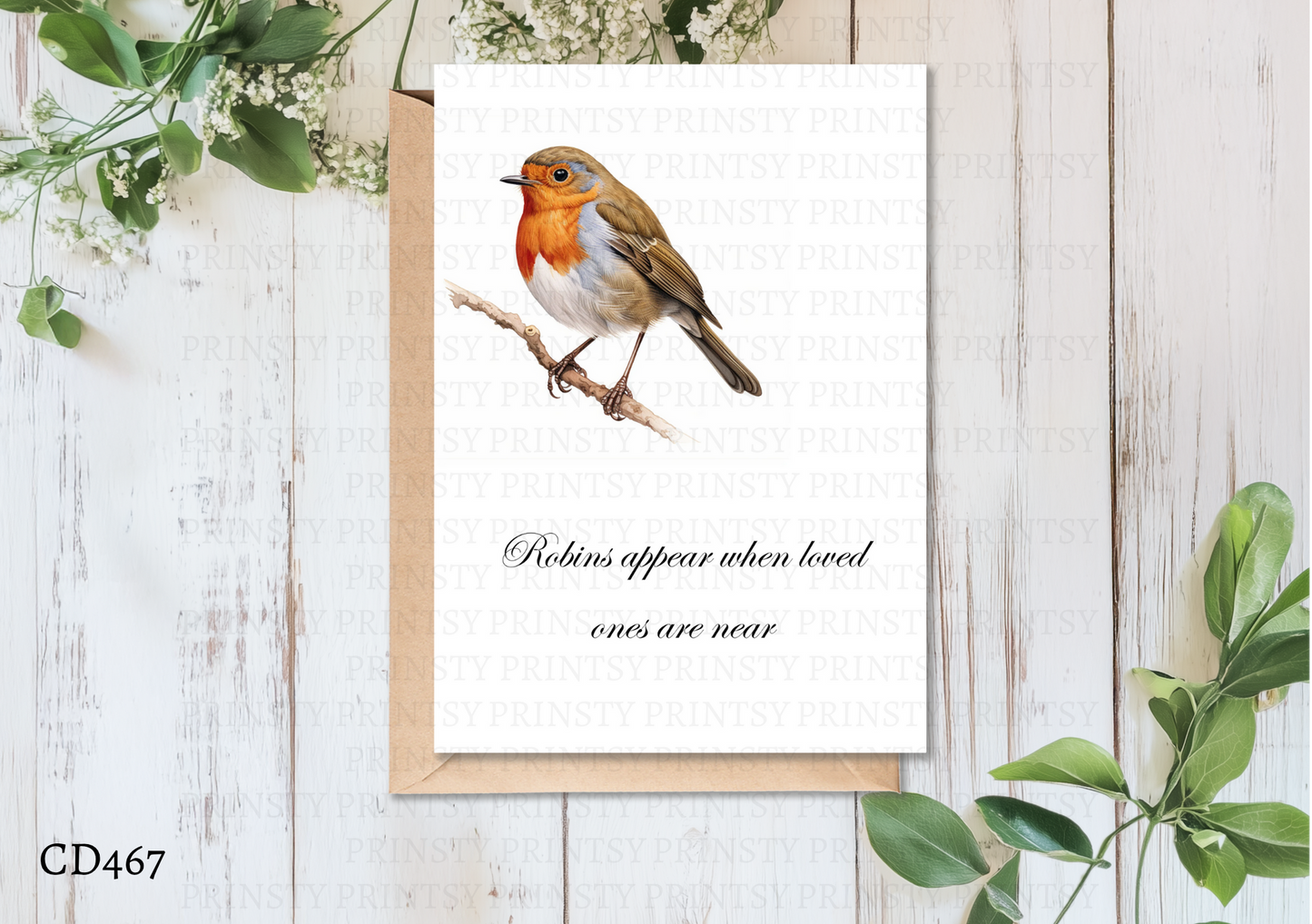 Print with a robin illustration and text on a wooden surface with greenery
