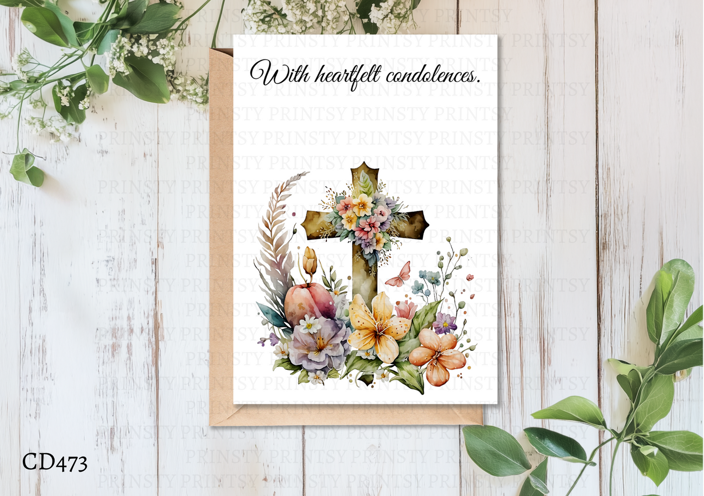 Greeting card with floral cross design on a wooden surface