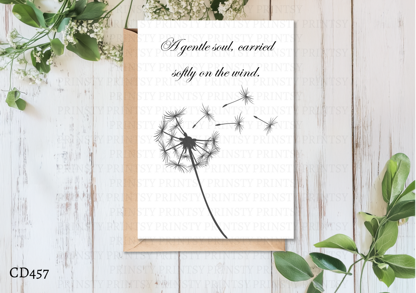 Greeting card with dandelion illustration and text on a wooden surface with greenery.